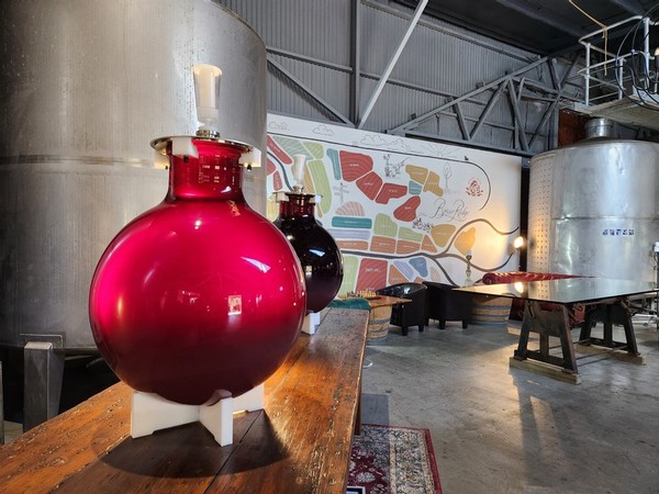 Our rosé filled glass wine globes in our Cellar Door.