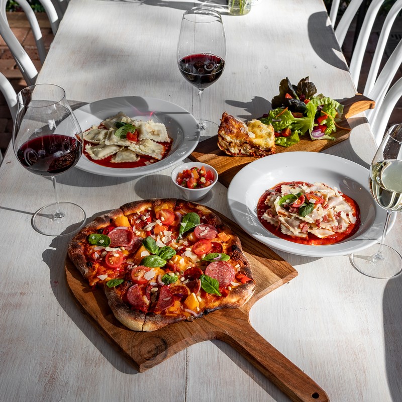 A table Briar Ridge's Osteria filled with Iconic Italian food and Hunter Valley Wine. Pizza, pasta, cheese, charcuterie and much more.