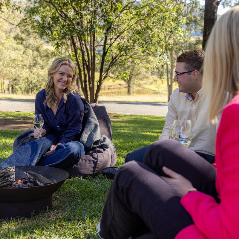 People sitting on beanbags in the Briar Ridge wine garden enjoying wine, platters and italian food.